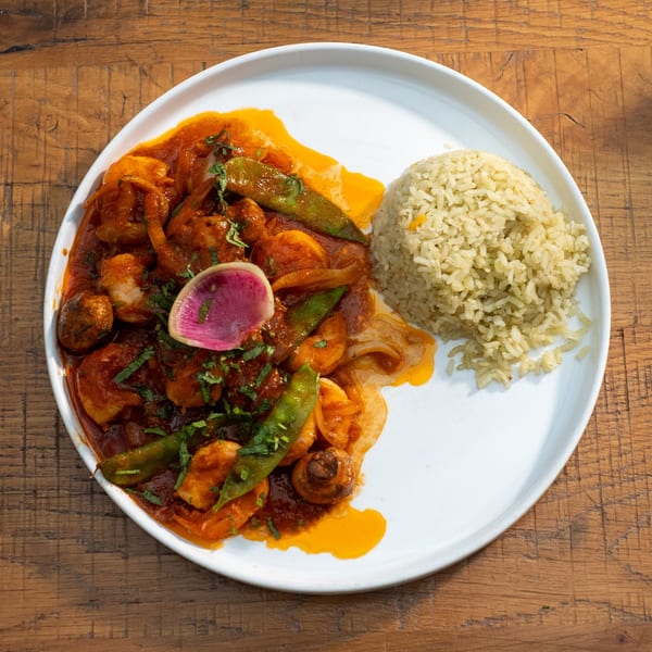 Mi Cava & Cocina's shrimp dish with red sauce, green beans, mushrooms, and a side of rice.