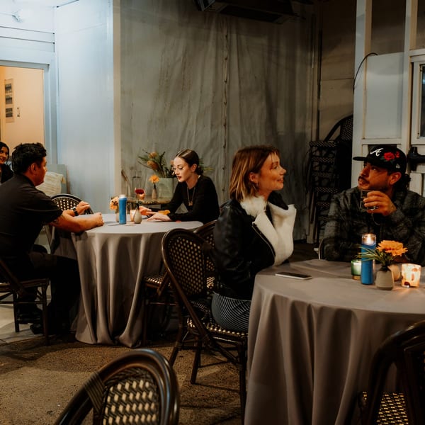 Couples dining at Mi Cava & Cocina, enjoying drinks and conversation at candlelit tables.